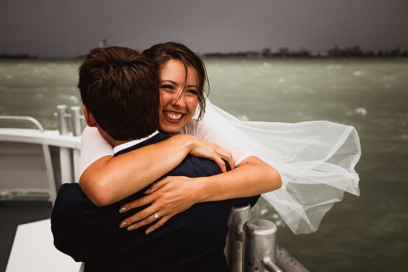 Bride and groom hugging on boat