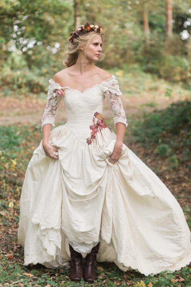 Bride wearing silk wedding dress with embroidered leaves and flowers