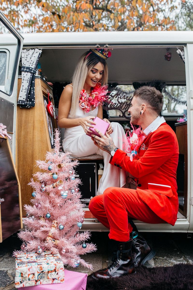 Bride handing groom Christmas present from VW van