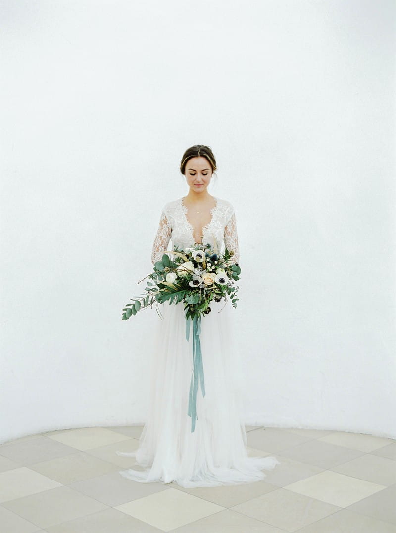 Elegant bride standing holding bouquet