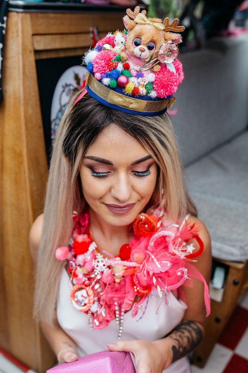 Bride wearing Christmas pom pom hat and necklace made from kitsch toys and ribbons