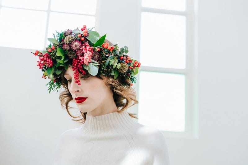 Bride wearing crown of green foliage and red berries