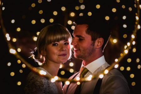 Bride and groom surrounded by fairy lights - Picture by Robin Goodlad Photography