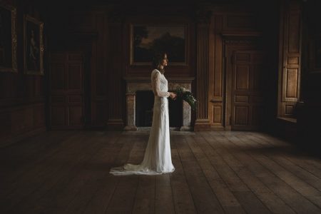 Bride standing holding bouquet in middle of room - Picture by Rik Pennington Photography