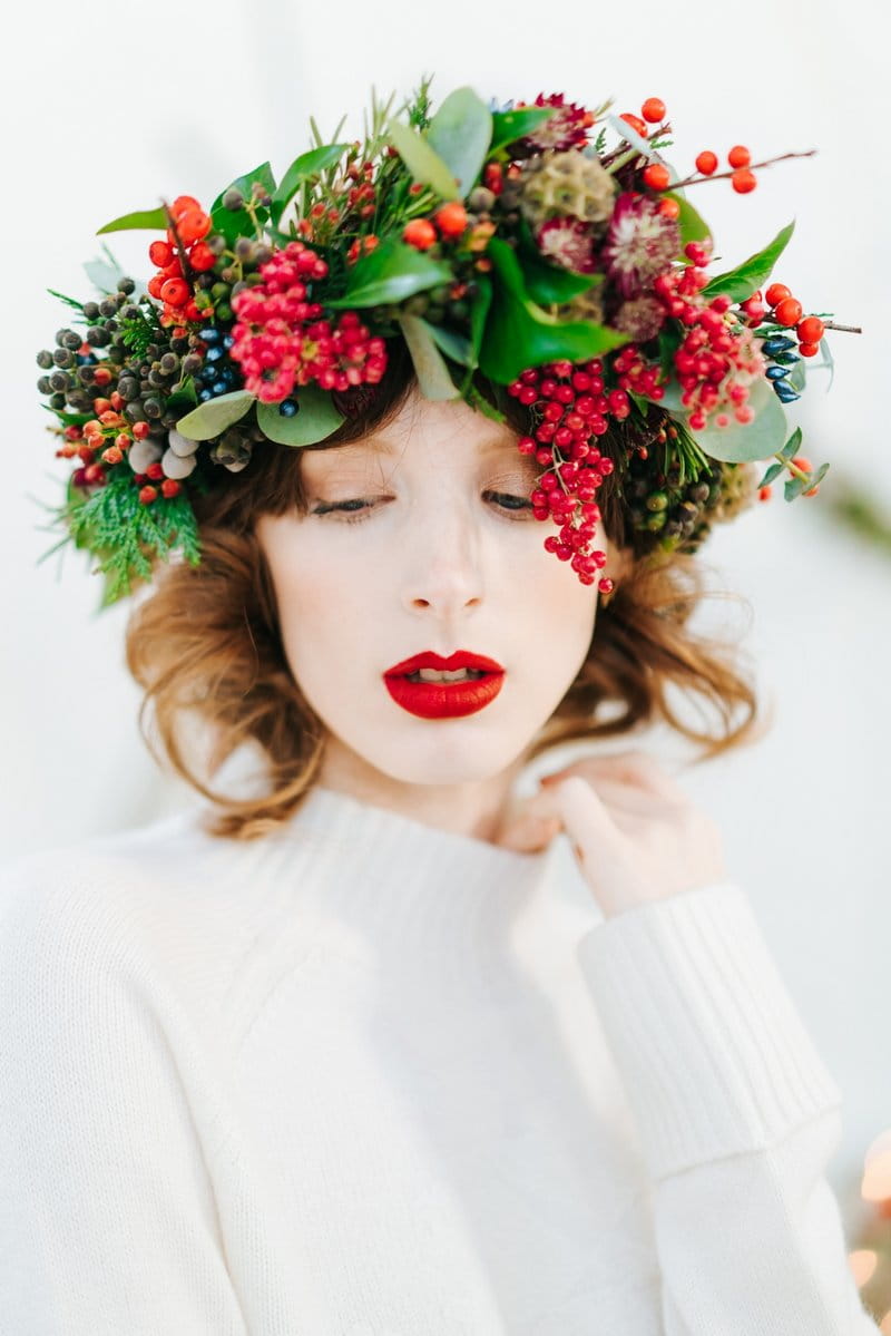 Bride with red lipstick and green foliage and red berry crown