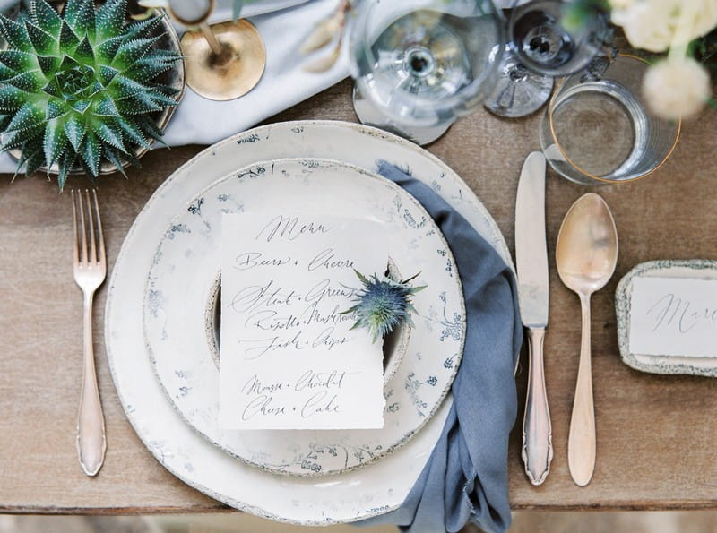 Wedding place setting with hand-written menu and grey napkin