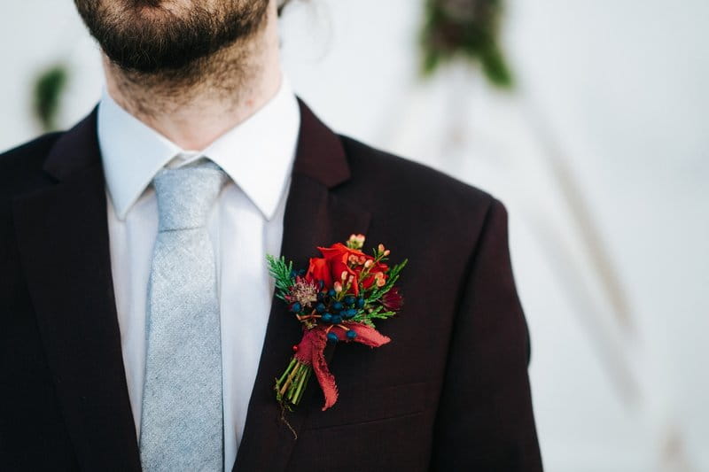 Groom wearing winter wedding buttonhole