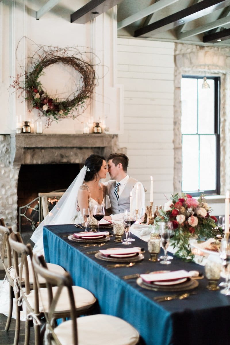 Bride and groom sitting at wedding table