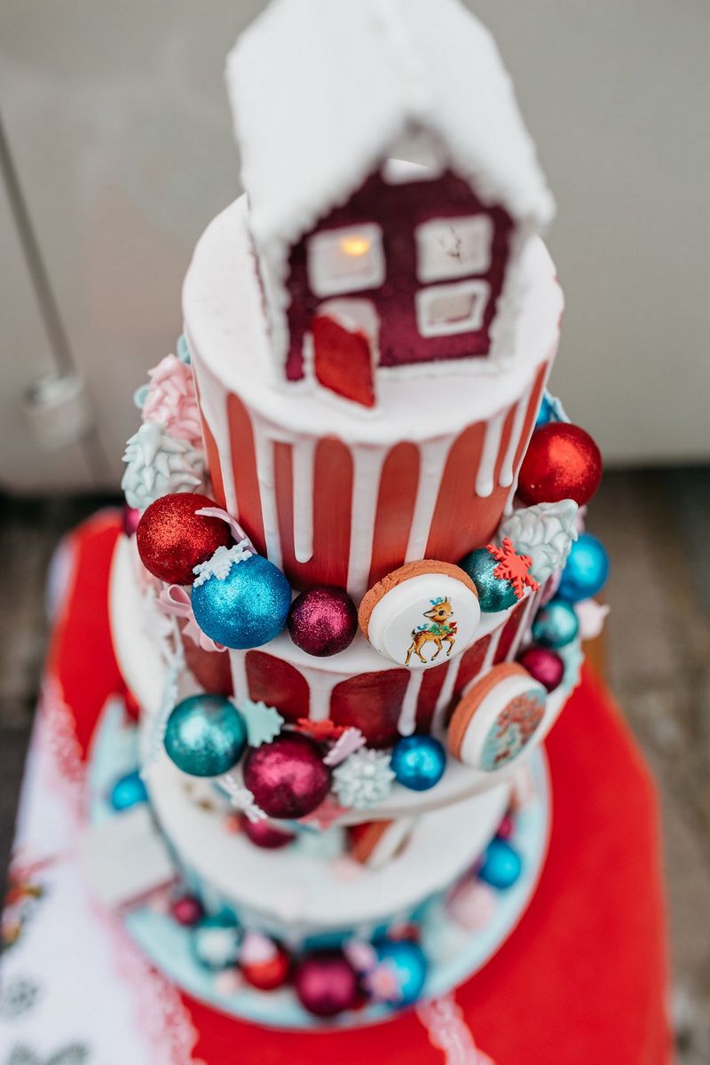 Red Christmas drip wedding cake with house topper