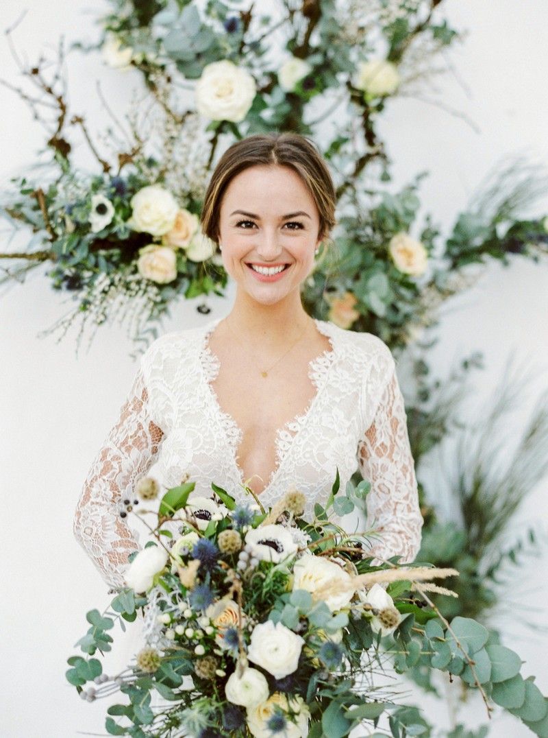 Smiling bride holding winter wedding bouquet