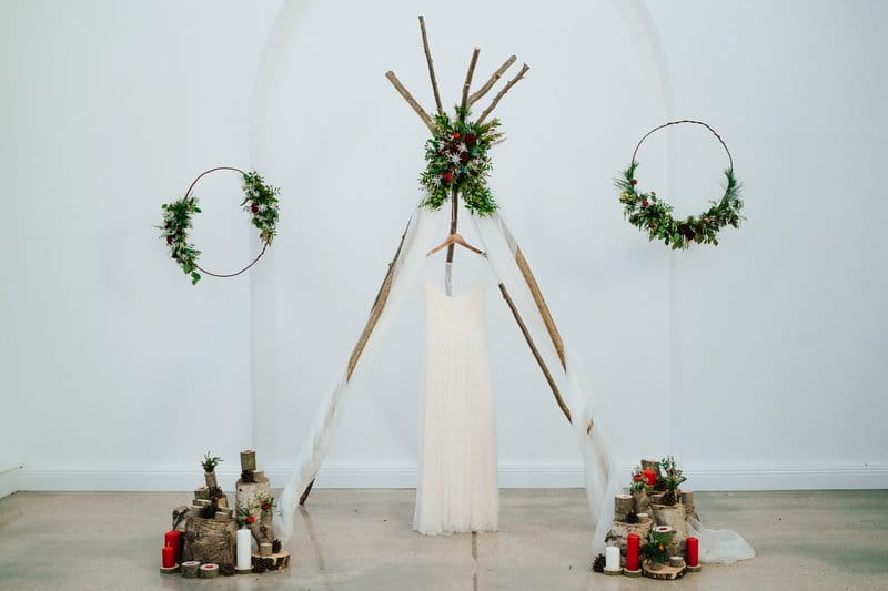 Wedding dress hanging from simple wedding ceremony tipi