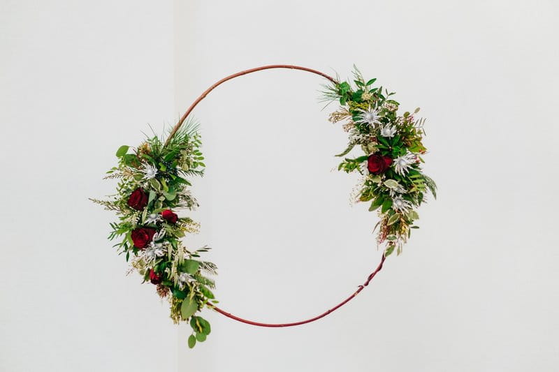 Hoop with green foliage and red flowers