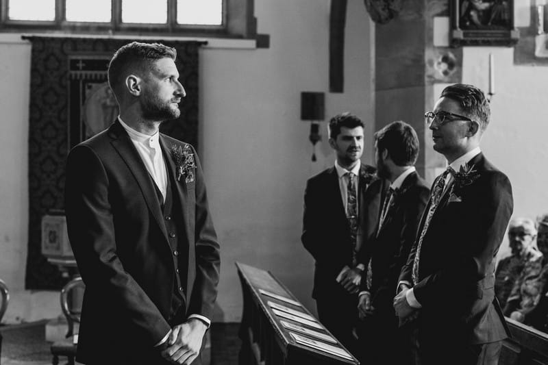 Nervous groom waiting for bride at altar