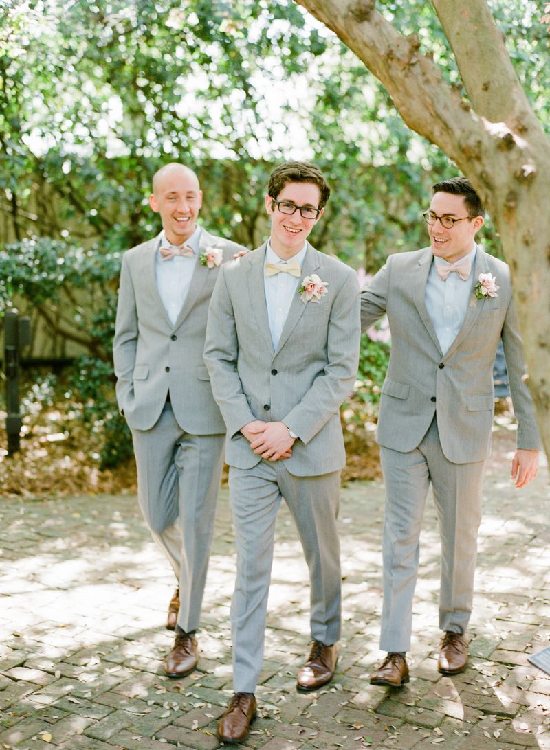 Groomsmen wearing light grey suits