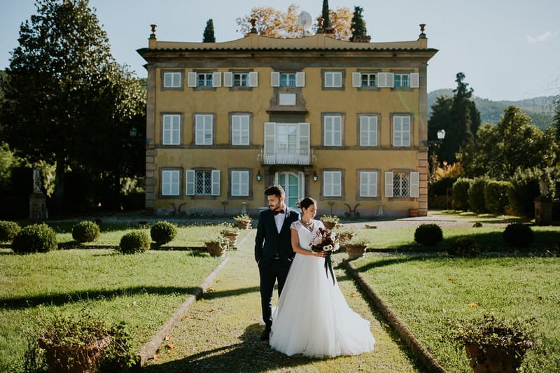 Bride and groom on path outside Villa Lenka, Tuscany