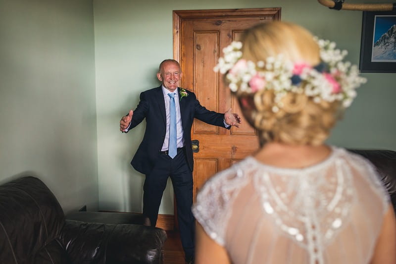 Happy father with arms out ready to hug bride - Picture by Andy Hudson Photography