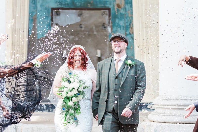 Peaky Blinders bride and groom walking through confetti shower - Picture by James and Kerrie Photography