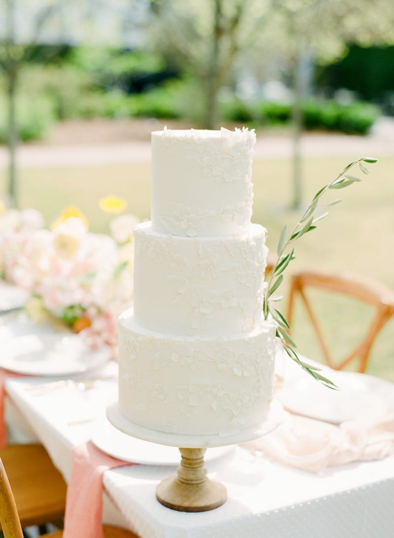 White wedding cake with sprig of Rosemary