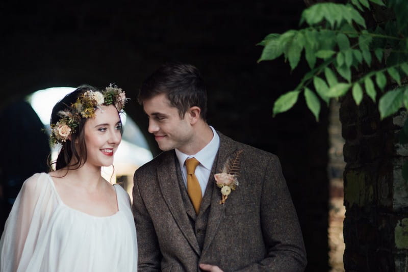 Bride with flower crown with groom in tweed jacket
