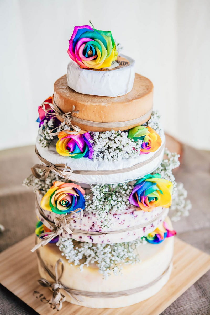 Cheese wedding cake decorated with colourful flowers