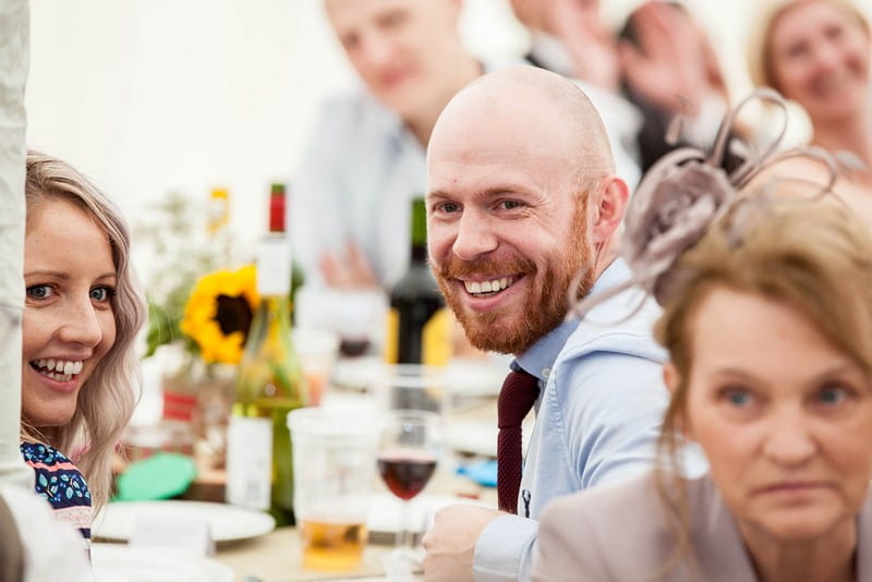 Guest smiling during wedding speech