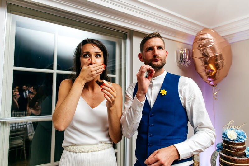 Bride and groom eating wedding cake