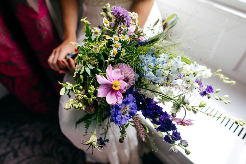 Bride holding wedding bouquet with foxgloves