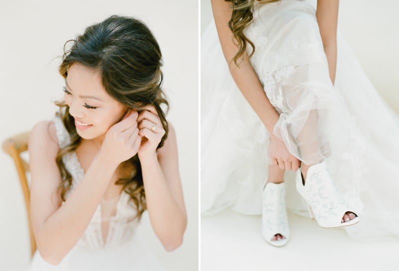 Bride putting on earrings and shoes