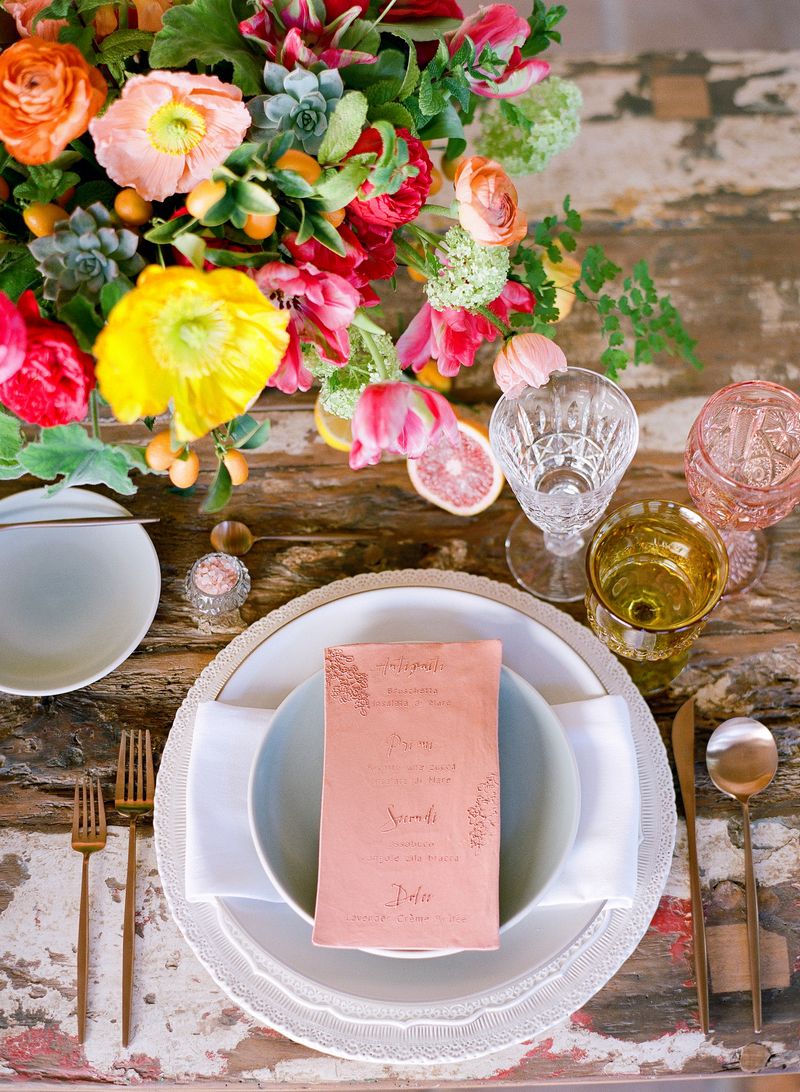 Wedding place setting with colourful flowers