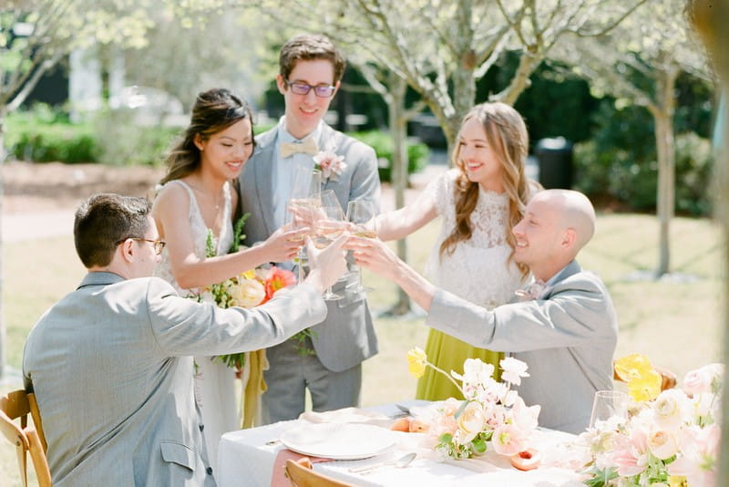 Bridal party toasting at outdoor wedding table