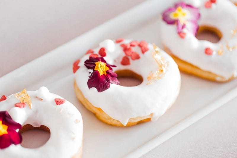 Iced doughnuts with edible flowers