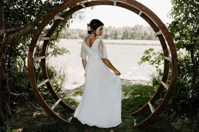 Bride standing in waterwheel