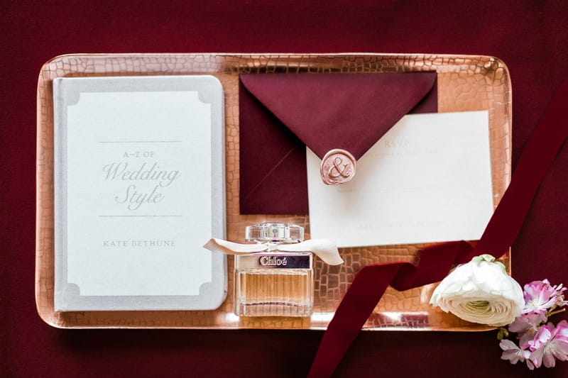 Engagement party invitation and perfume on rectangular tray