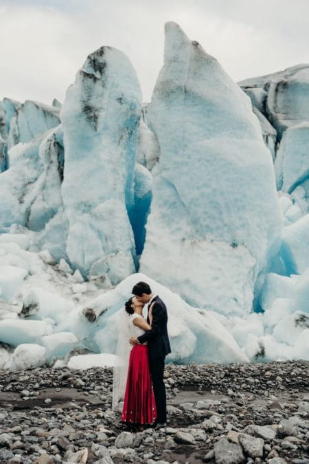 Bride and groom kissing in front of glacier - Picture by Kristian Irey Photography