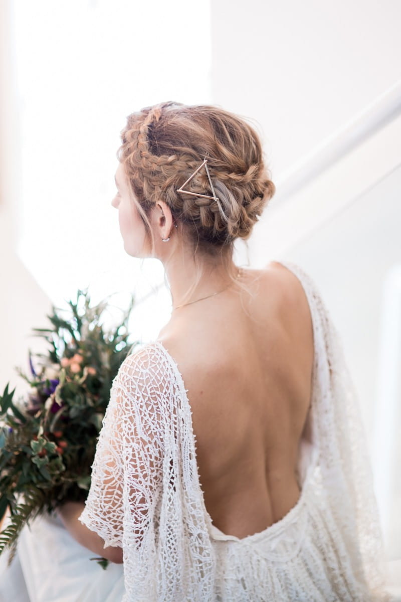 Bride with plait updo and open back wedding dress