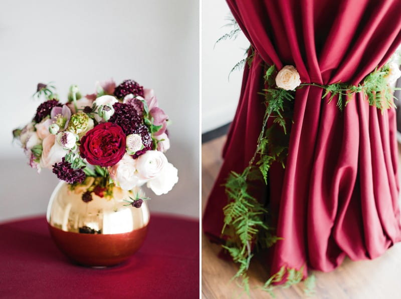 Small metallic vase of flowers and foliage wrapped around tablecloth