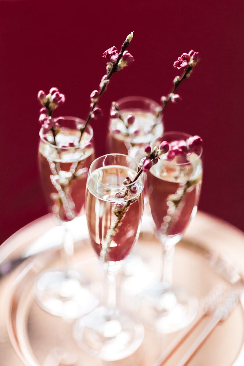 Glasses of champagne with sprigs of cherry blossom