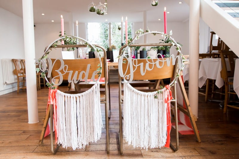 Wedding chairs with bride and groom hoops on the back