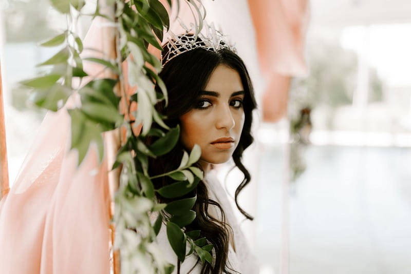 Bride with crown behind foliage