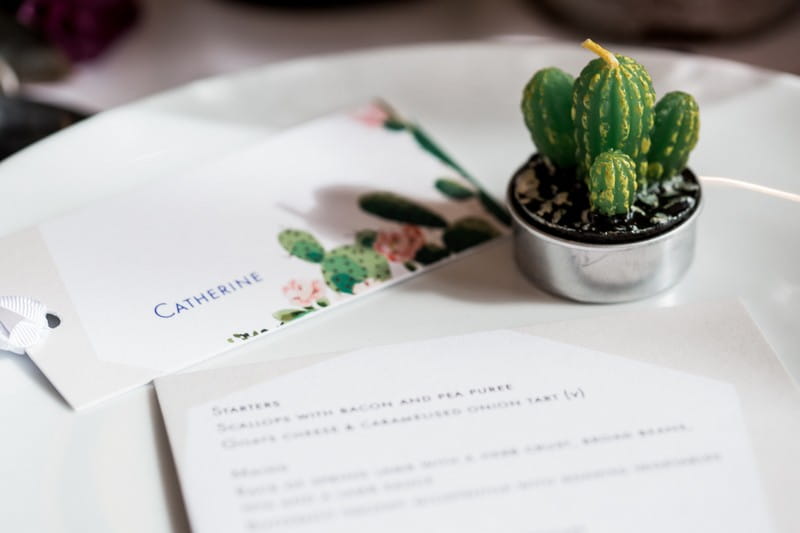 Small cactus plant and cactus name tag at wedding place setting