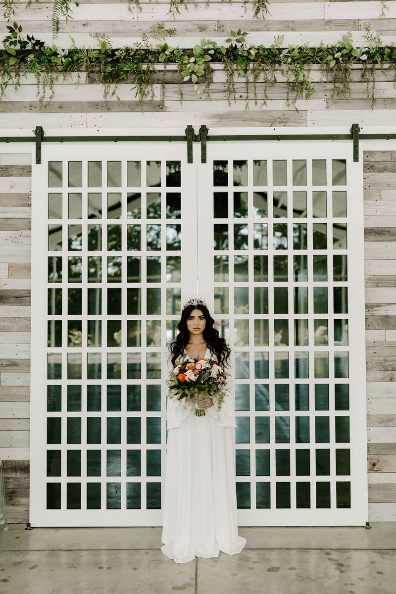 Bride standing in front of doors