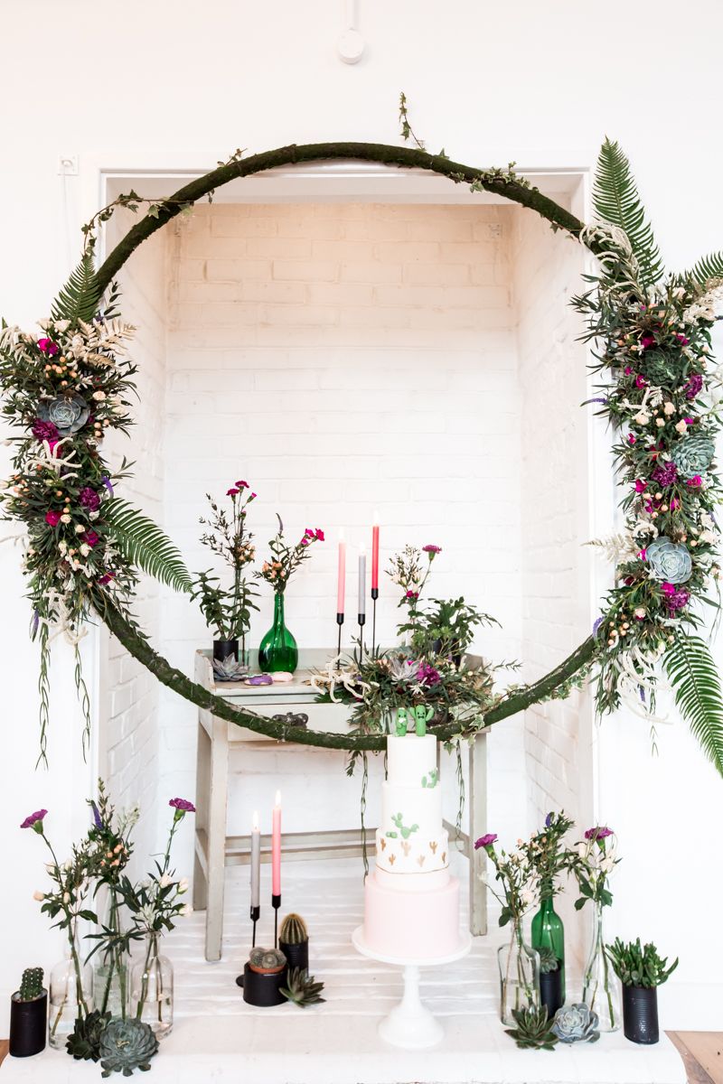 Wedding ceremony display with floral hoop and vases of flowers