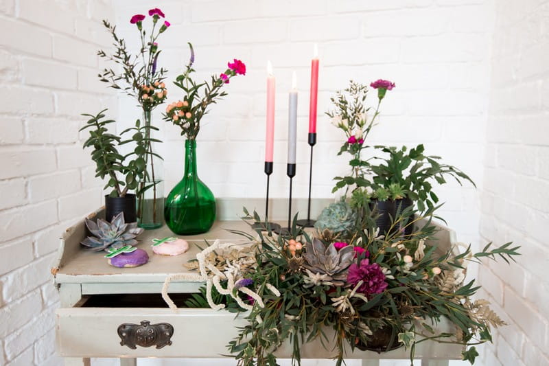 Dresser decorated with flowers and candles