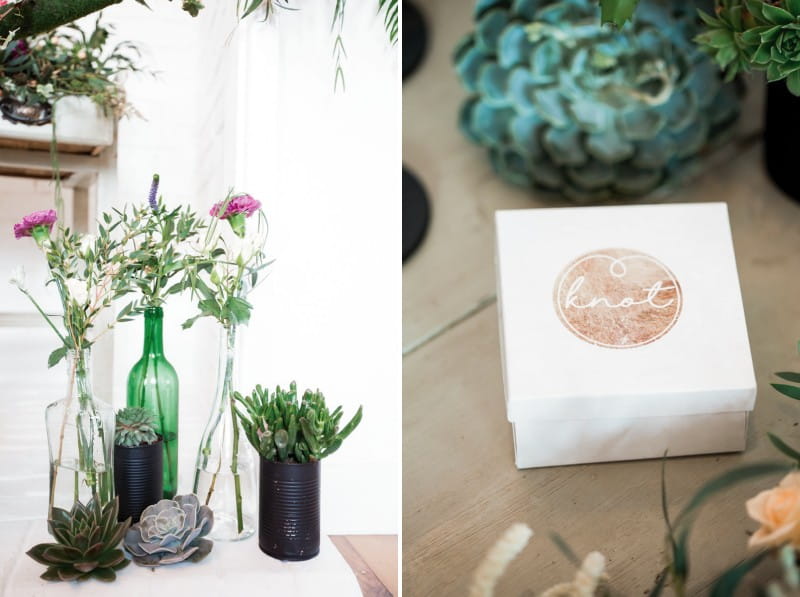 Bottles and black tins of flowers with jewellery box