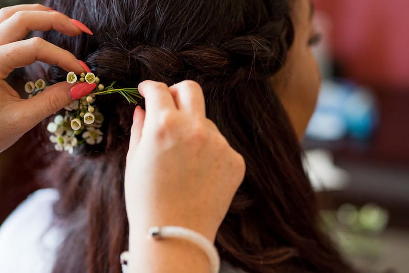 Flowers in bridesmaid's braid hairstyle