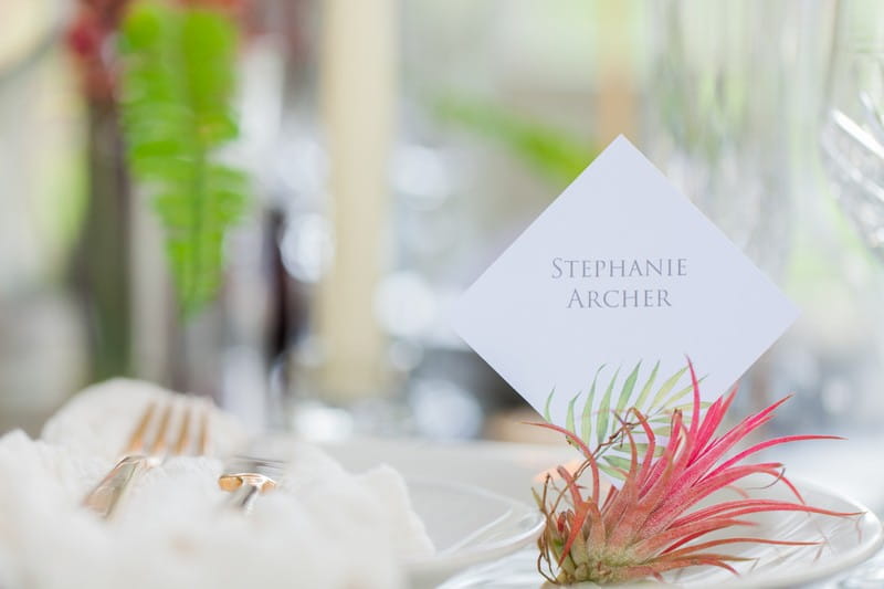 Elegant wedding name card with tropical leaf design