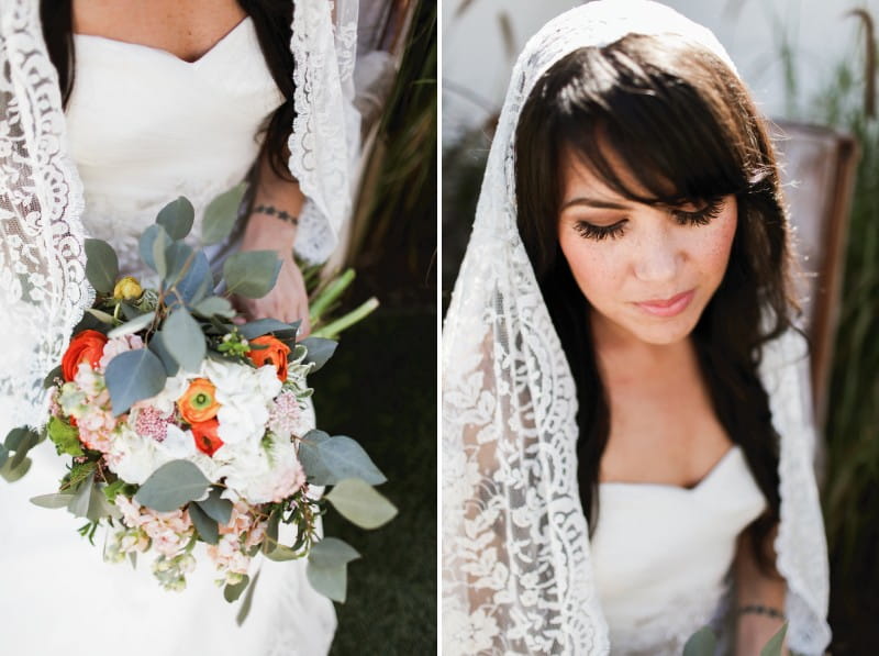 Bride with lace veil and bouquet with green foliage and orange flowers