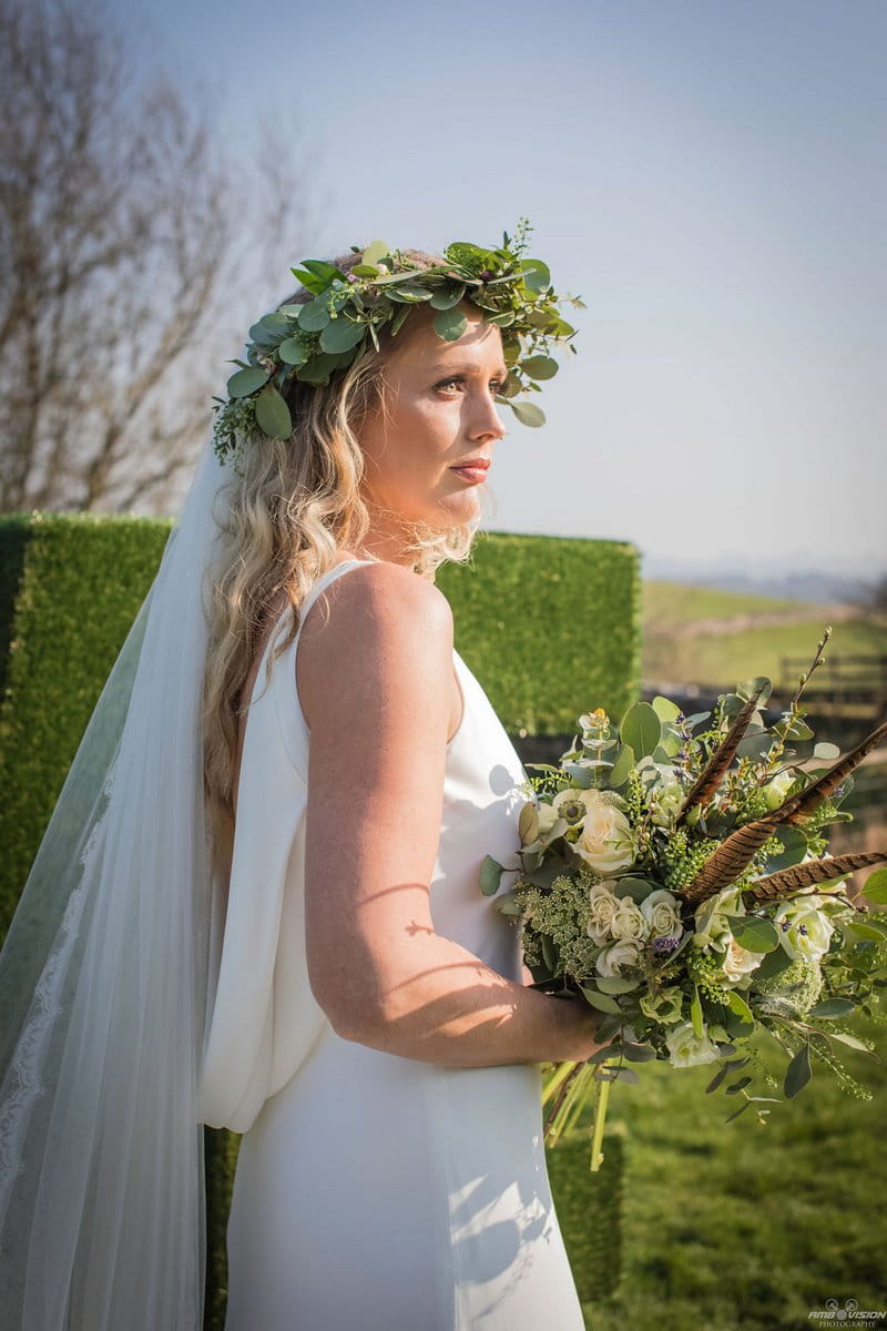 Bride wearing rustic foliage crown and holding bouquet