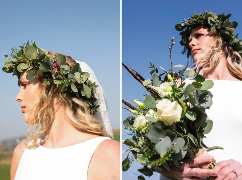 Bride with foliage crown holding bouquet with pheasant feathers