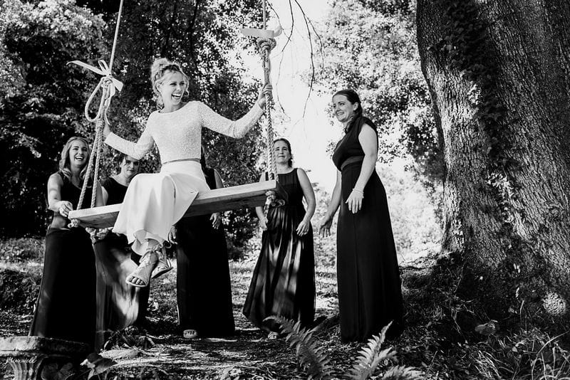 Bridesmaids pushing bride on tree rope swing - Picture by Lee Maxwell Photography